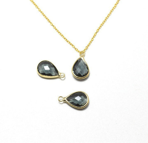 Vente au détail pendentif perle en verre à facettes gris 18x11x5mm avec contours dorés